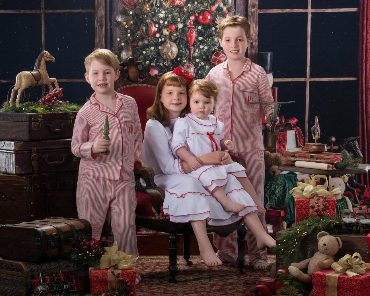 Four siblings in matching pajamas before a decorated Christmas tree, a Blackwater fine art portrait
