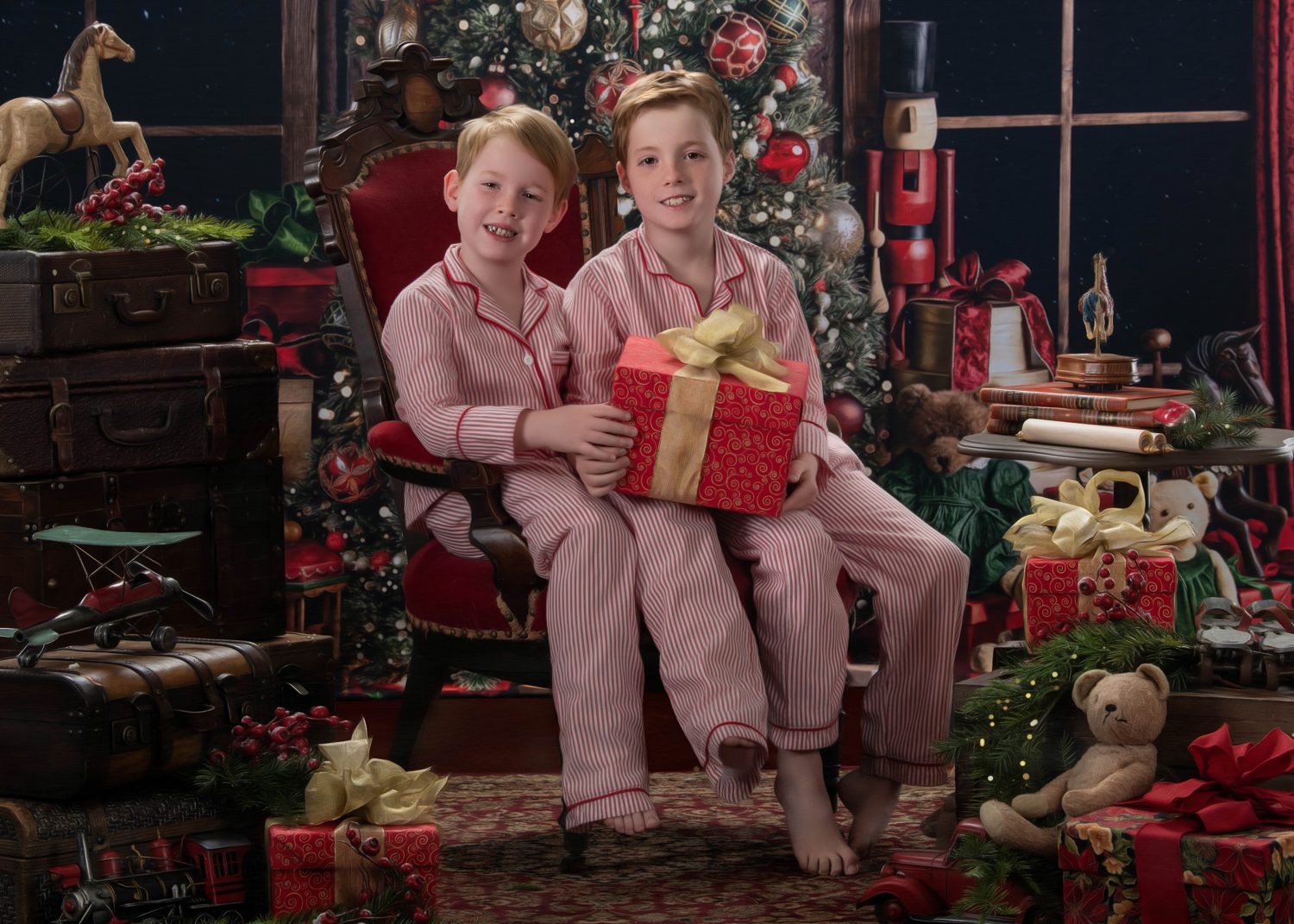 Two brothers in striped pajamas holding a wrapped gift on the Christmas set, a Blackwater fine art portrait