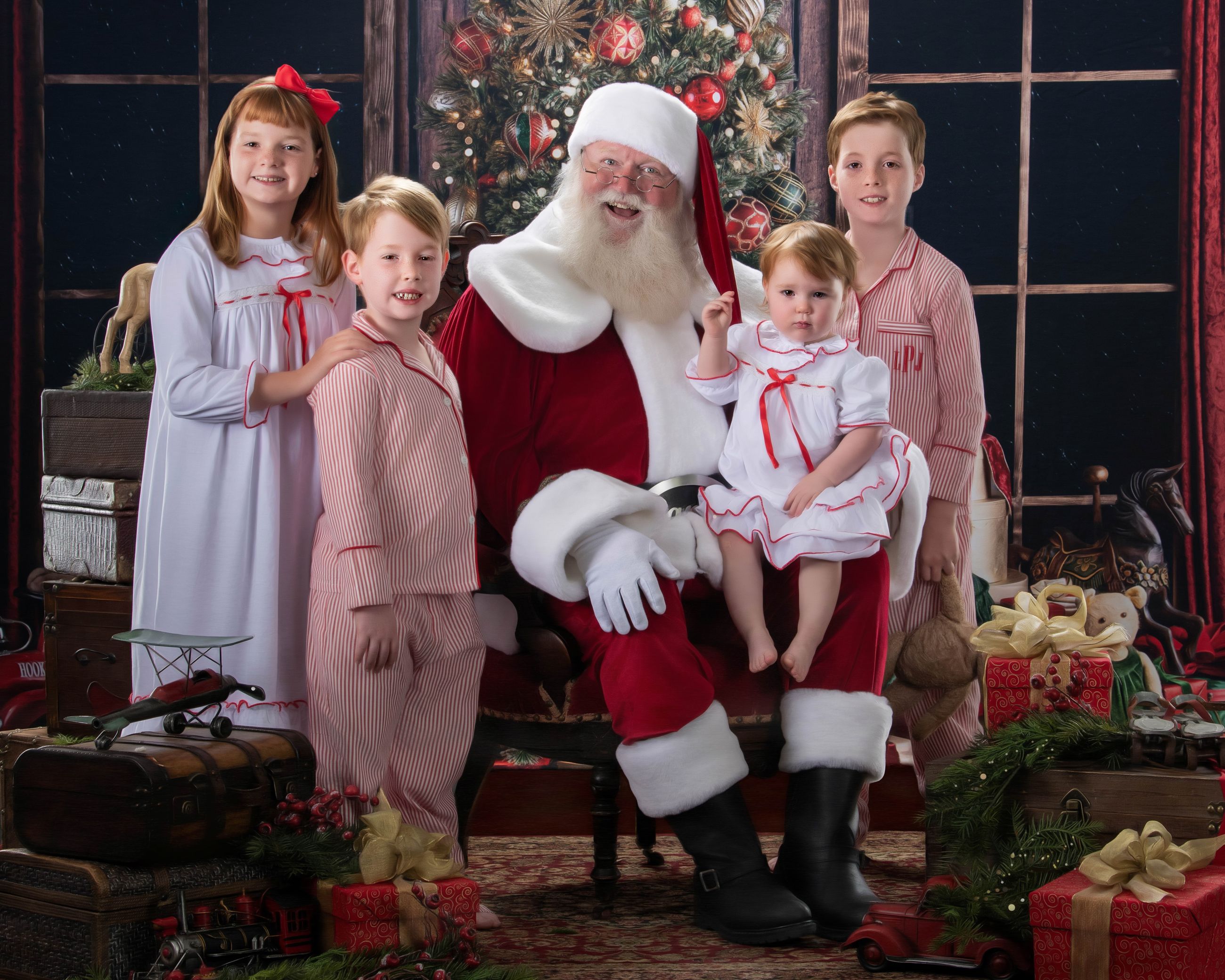 Santa seated with four children around him on a styled Christmas set, a Blackwater fine art Santa portrait