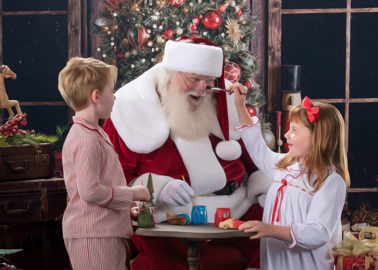 A child painting Santa's nose with a paintbrush at the craft table, a candid Blackwater fine art Santa moment